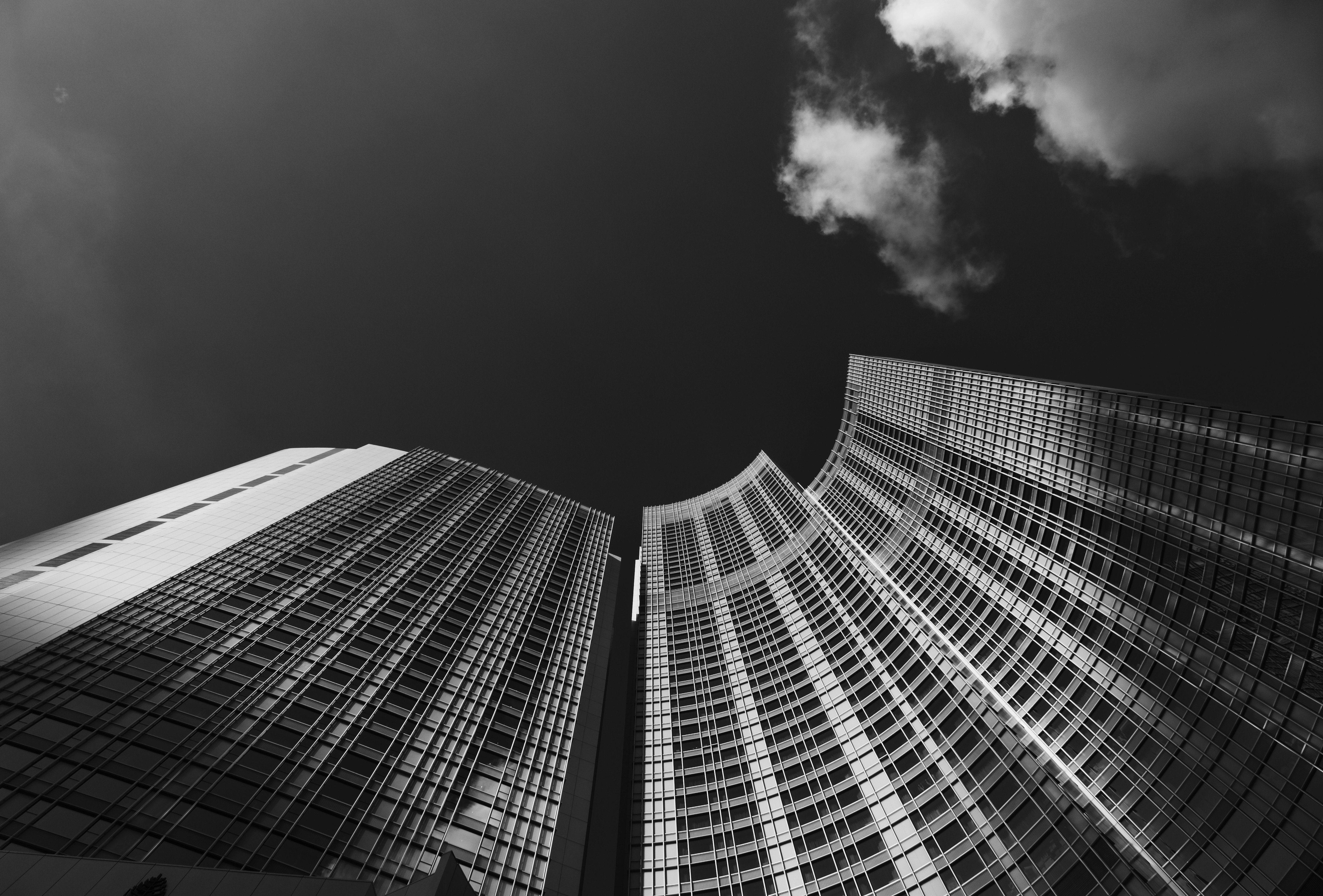 low angle grayscale photography of skyscraper